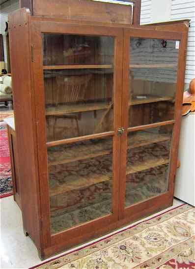 Appraisal: AN OAK CABINET BOOKCASE American Arts Crafts influence c having