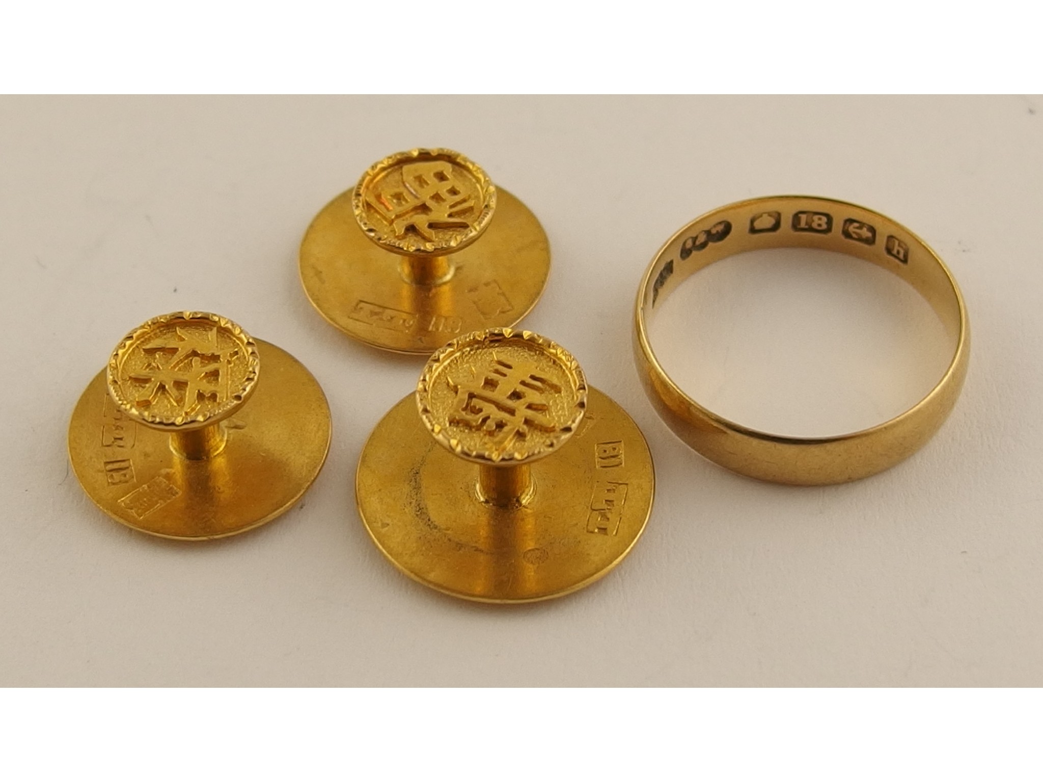 Appraisal: An ct gold wedding band together with three Chinese gold