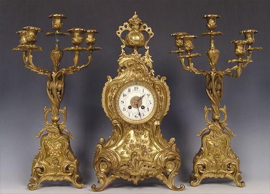 Appraisal: FRENCH BRONZED CLOCK GARNITURE Cast bronzed metal case clock with