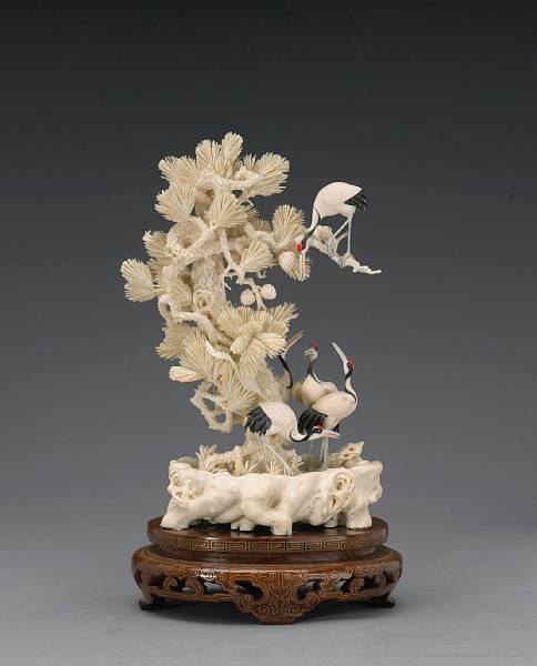 Appraisal: A pieced and tinted ivory crane and tree group th