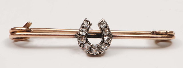 Appraisal: A bar broochof horse-shoe shaped fitting with diamond chip settings