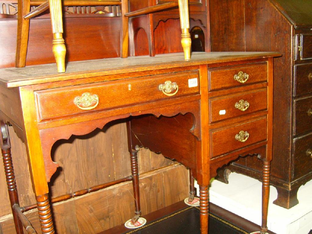 Appraisal: An Edwardian mahogany writing desk with raised upper section incorporating