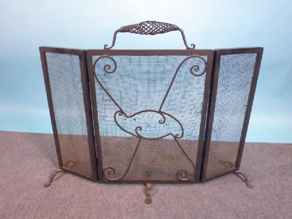 Appraisal: A wrought iron adjustable spark guard in the art and