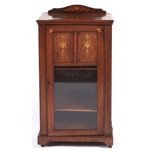 Appraisal: An Edwardian rosewood and inlaid music cabinet with shell paterae