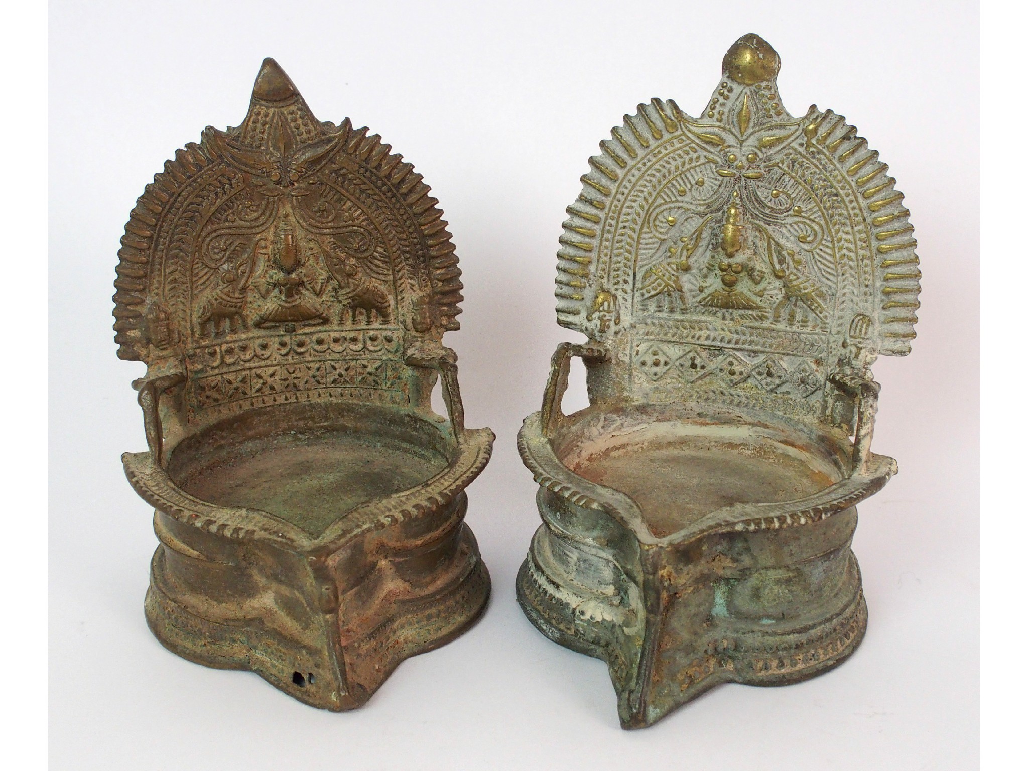 Appraisal: A pair of Tibetan brass altar lampscast with radiating backs