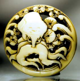 Appraisal: ANTIQUE IVORY NETSUKE Antique carved ivory two-part ryusa manju netsuke