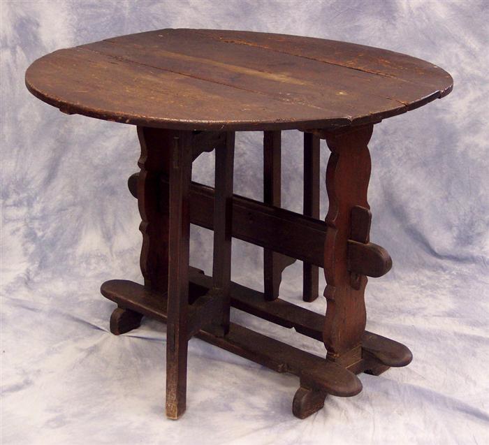 Appraisal: Oak trestle base gateleg table English th c rounded leaves