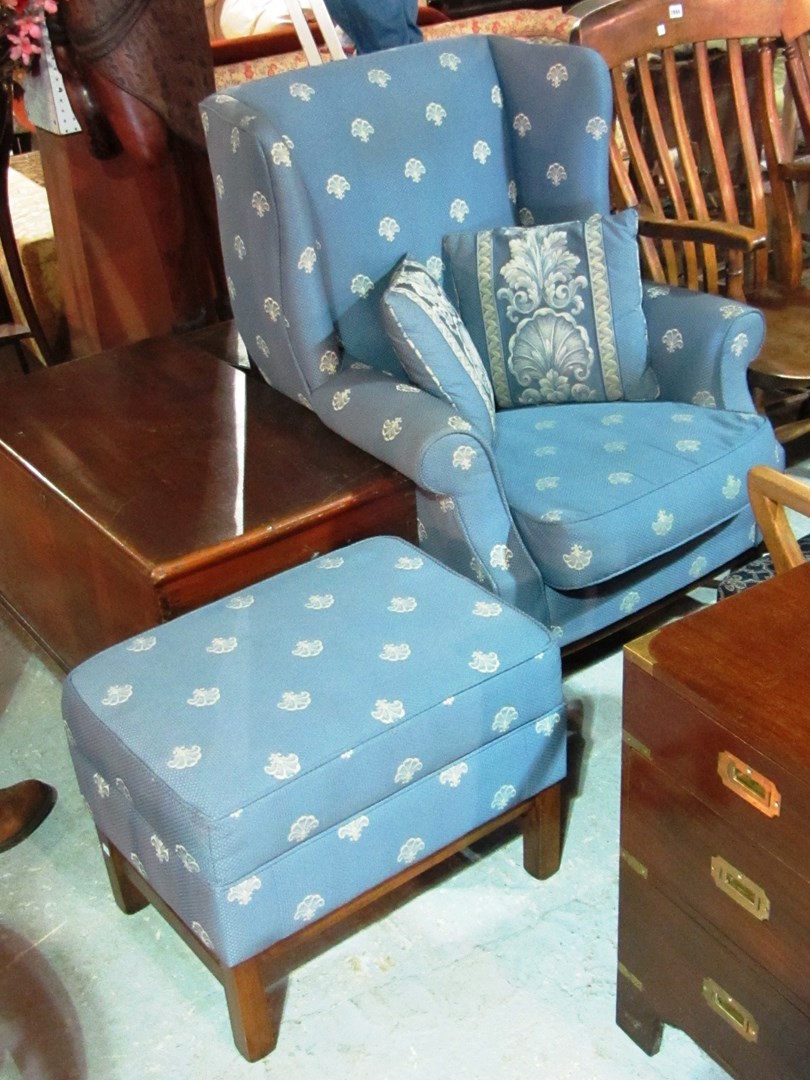 Appraisal: A th century blue upholstered wing back armchair with matching