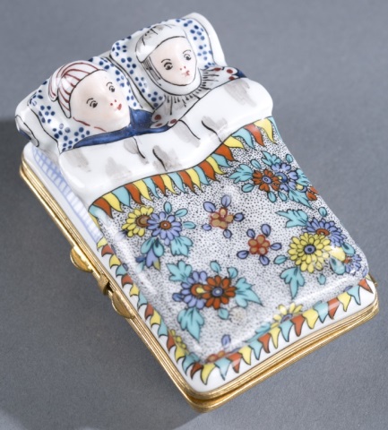 Appraisal: Hand-Painted Porcelain Pill Box Man and woman laying in a