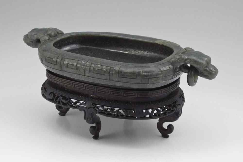 Appraisal: CHINESE CARVED STONE BOWL ON STAND Carved with figural mythological