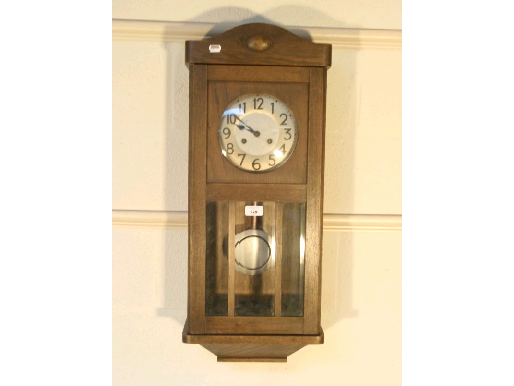 Appraisal: An oak cased eight-day wall clock