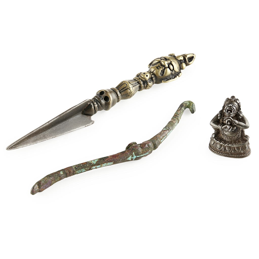 Appraisal: BRONZE RITUAL PHURBA the faceted-triangular blade below a vajra-shaped handle