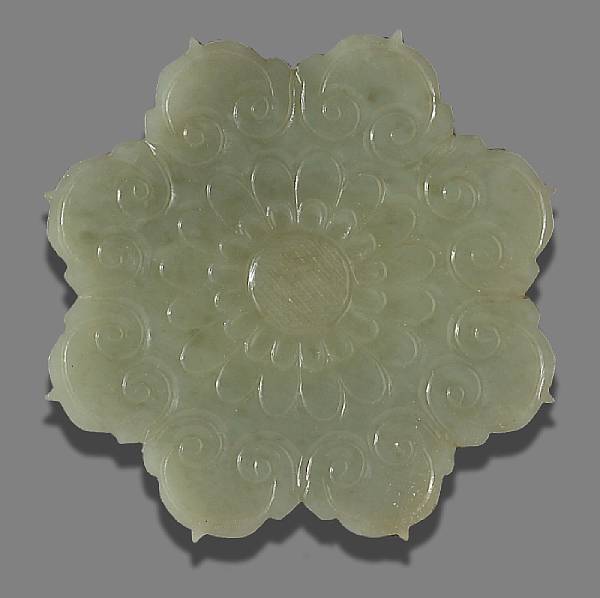 Appraisal: A greenish white jade floriform plaque The eight-petaled plaque carved