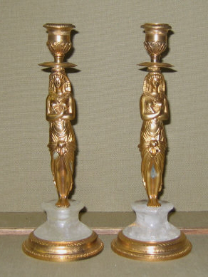 Appraisal: PAIR OF EMPIRE STYLE FIGURAL CANDLESTICKS Molded as Egyptian female