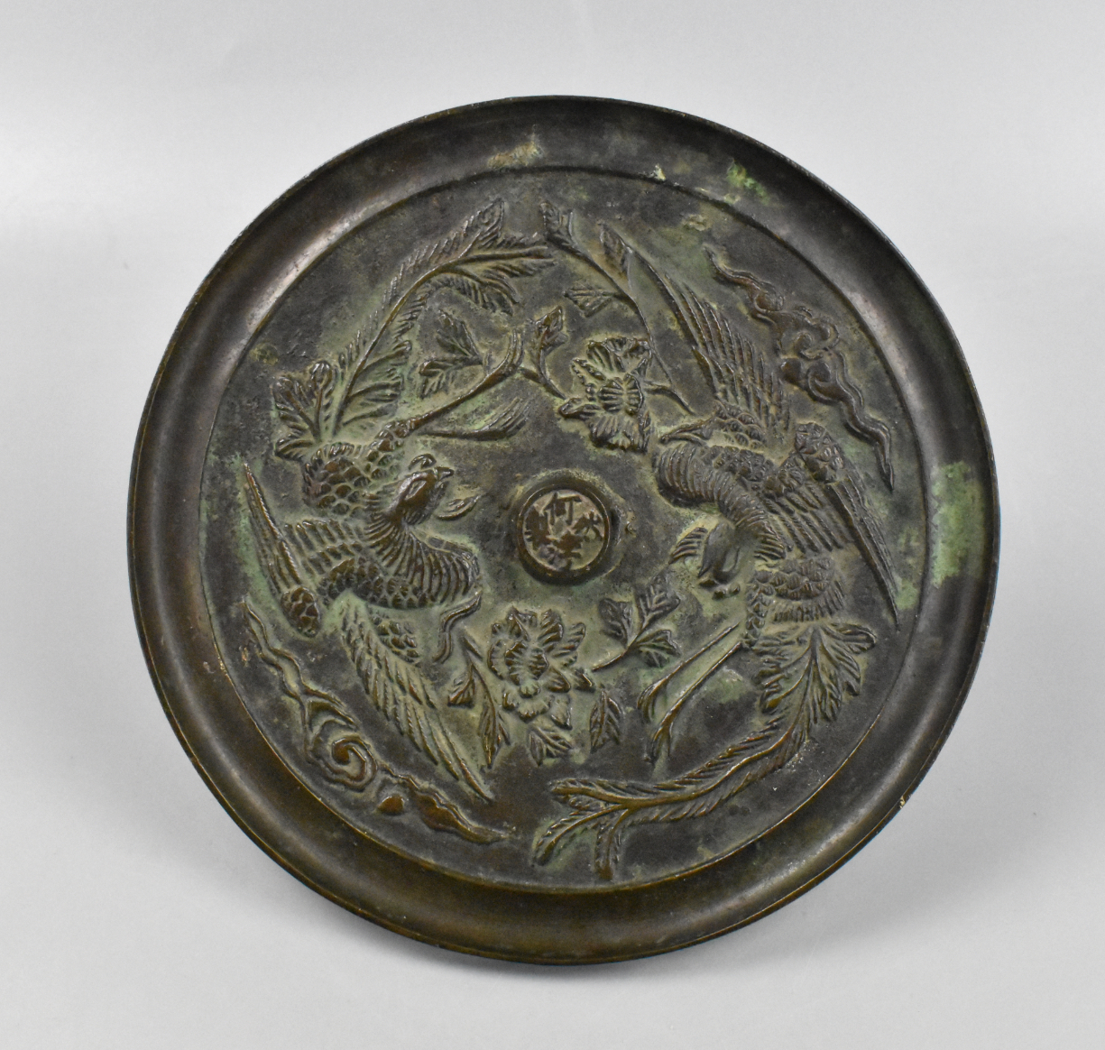 Appraisal: A Chinese bronze mirror with Phoenix dating from the century