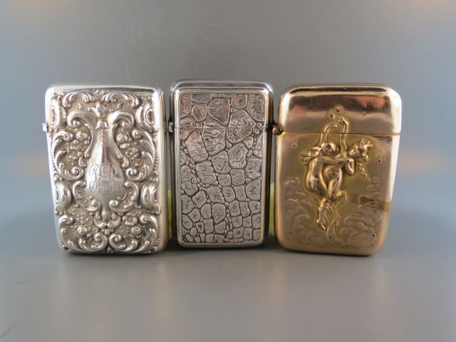 Appraisal: Antique Match Safes frolicking nudes aligator texture and rococo silverplate