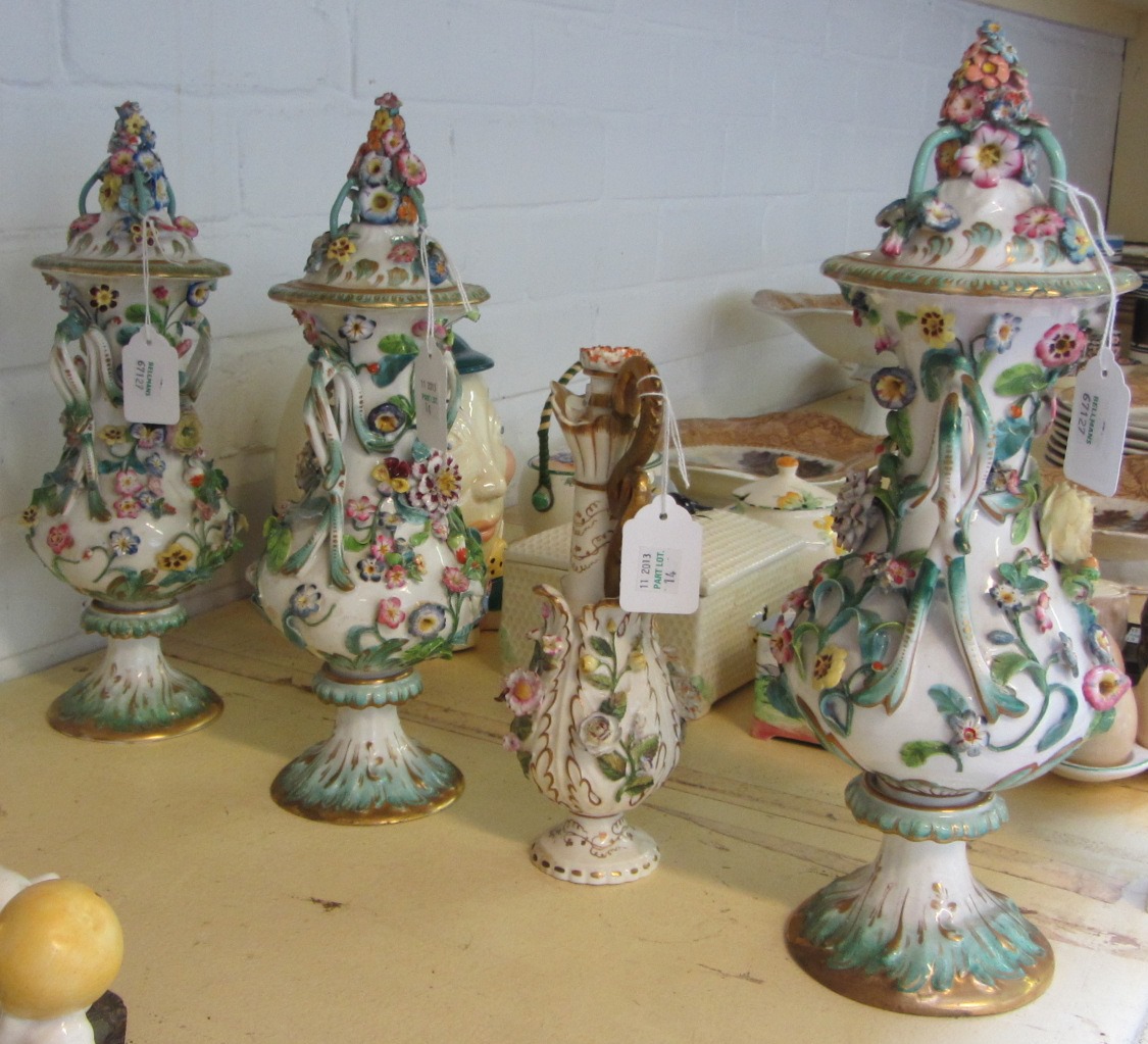 Appraisal: A garniture of three Staffordshire porcelain vases and covers th