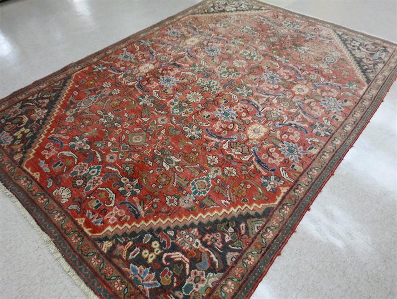 Appraisal: SEMI-ANTIQUE PERSIAN CARPET overall floral design on red ground hand