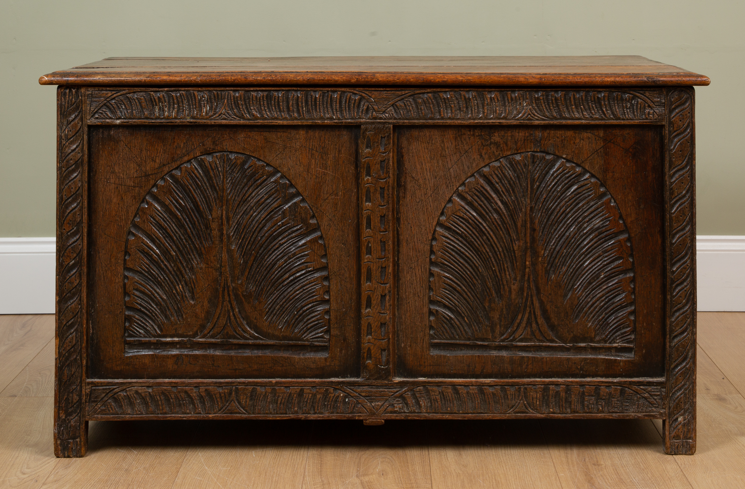 Appraisal: An antique oak panelled chest or coffer with chip carved