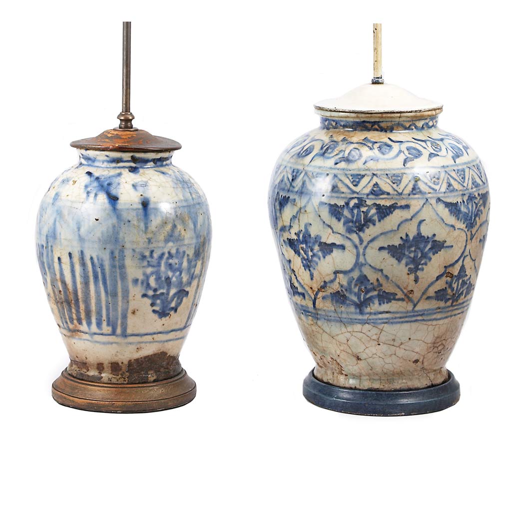 Appraisal: Two Islamic Style Pottery Lamps Each decorated with cobalt scrolls