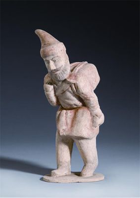 Appraisal: A Chinese unglazed pottery model of a foreigner carrying a