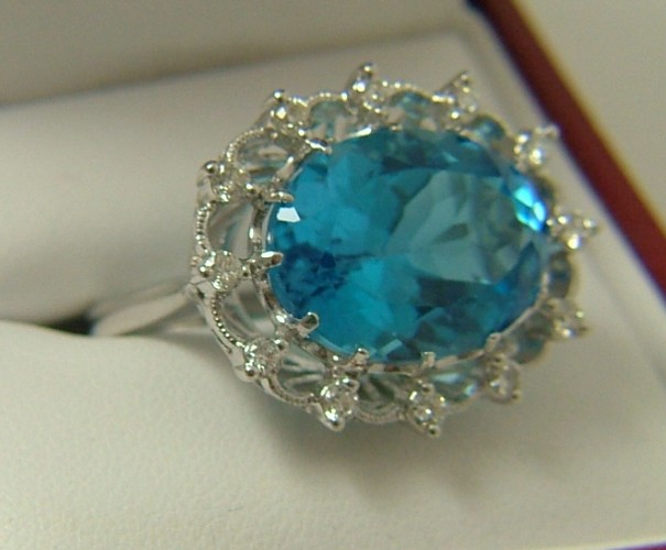 Appraisal: BLUE TOPAZ DIAMOND AND FOURTEEN KARAT GOLD RING centered and