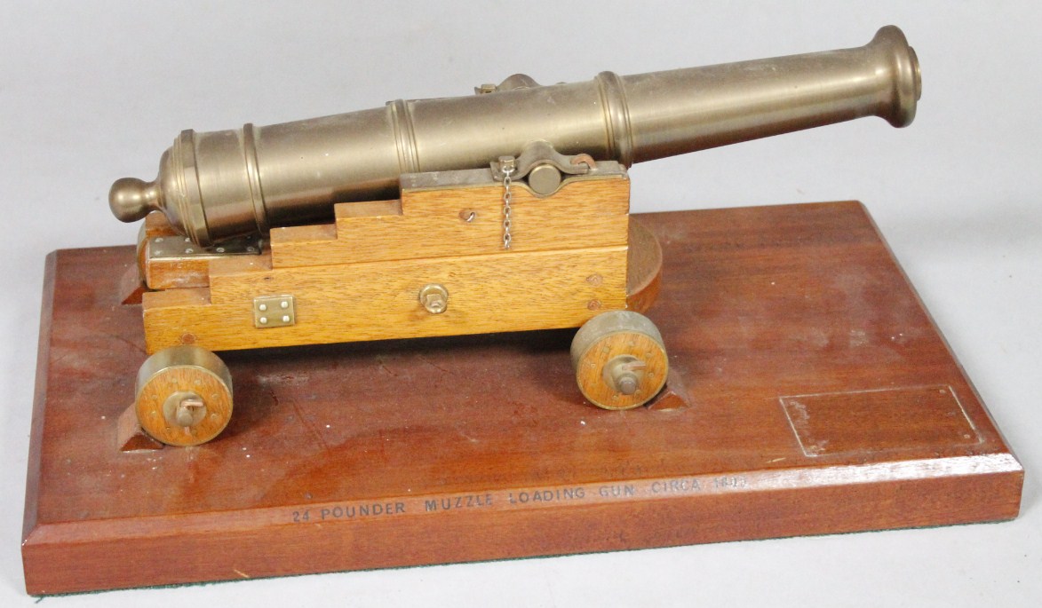 Appraisal: A thC brass table top model of a cannon with