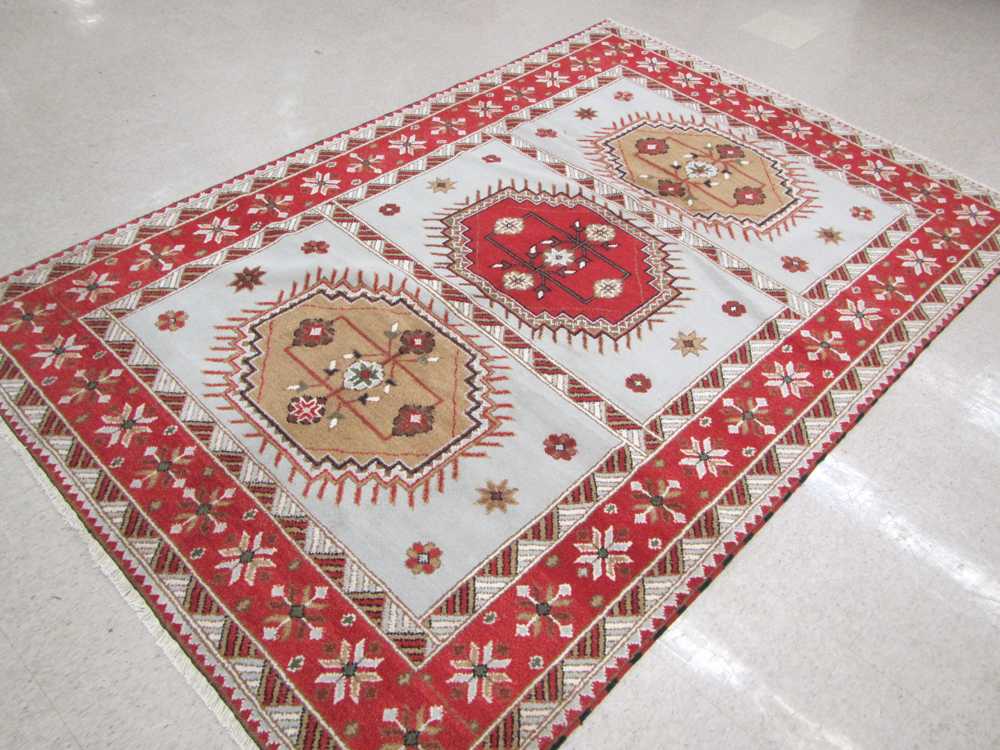 Appraisal: HAND KNOTTED ORIENTAL CARPET Indo-Caucasian triple flower-filled octagonal medallion design