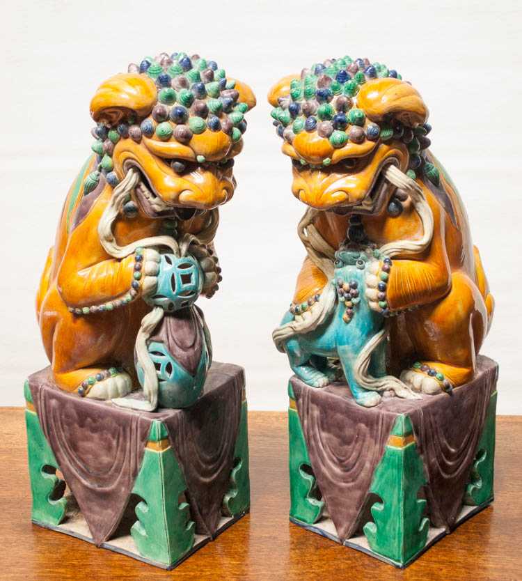 Appraisal: PAIR OF CHINESE PORCELAIN FOO-DOGS seated male and female figures