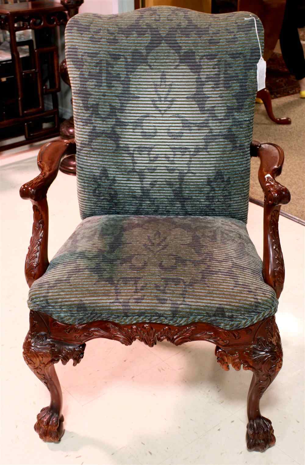 Appraisal: CHIPPENDALE STYLE CARVED MAHOGANY LIBRARY ARMCHAIR the serpentine padded backrest