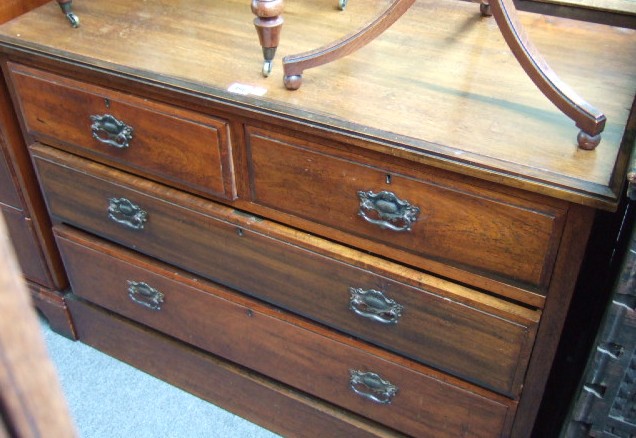 Appraisal: An Edwardian walnut chest of two short and three long