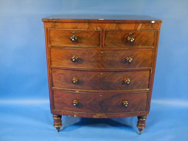 Appraisal: A William IV flame mahogany bow front chest with two