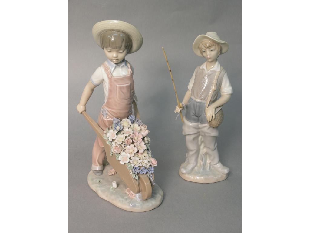 Appraisal: Two Lladro figures boy with flower filled barrow in a