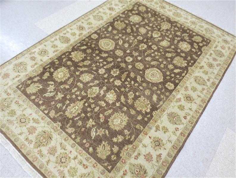 Appraisal: HAND KNOTTED ORIENTAL CARPET Pakistani-Persian overall floral design on mocha