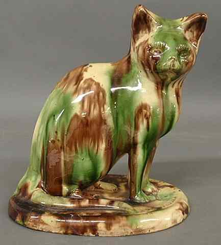 Appraisal: Redware seated cat with mottled green and brown glazing th