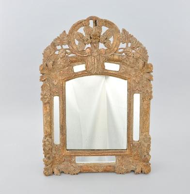 Appraisal: A Baroque Provincial Style Gilt Framed Mirror The carved wood