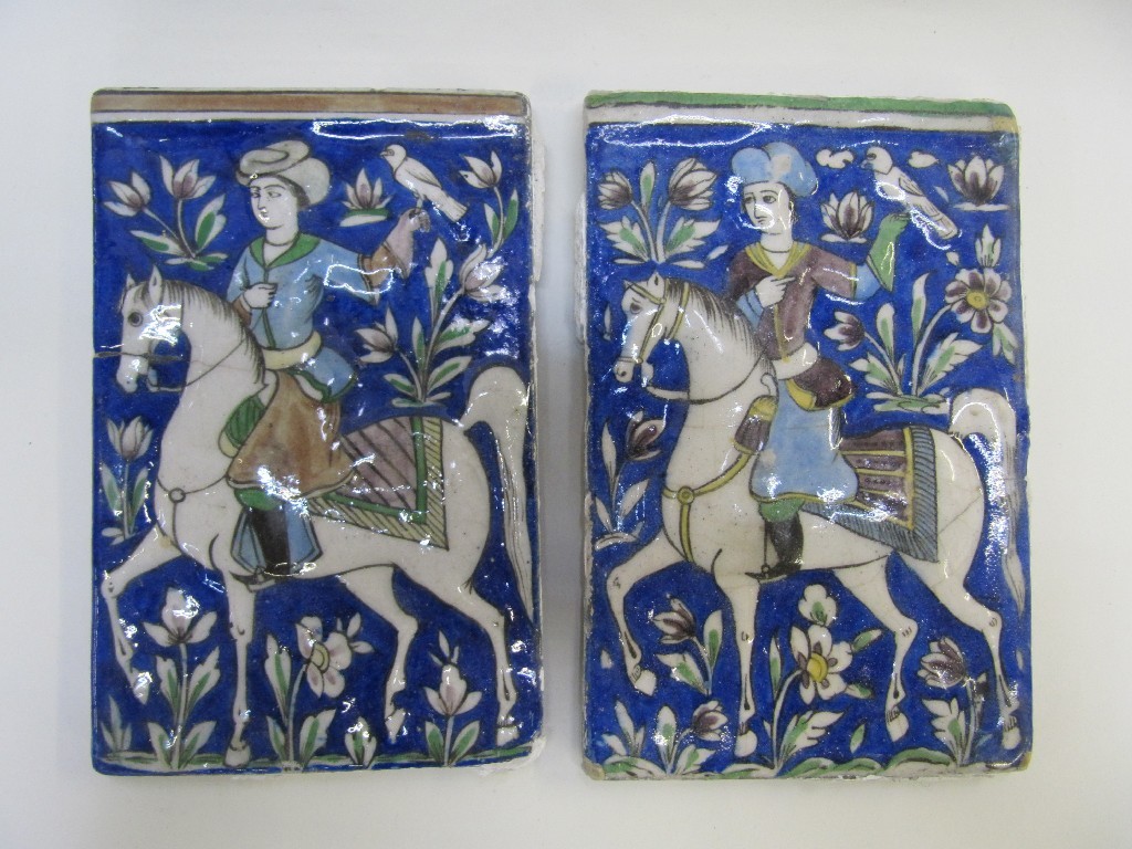 Appraisal: Two Persian tiles each decorated with a man on horseback