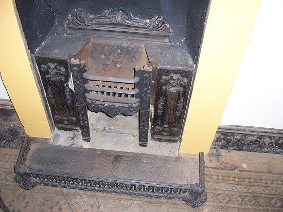 Appraisal: A cast iron fire grate and fender