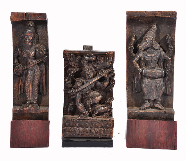 Appraisal: A PAIR OF INDIAN CARVED HARDWOOD DEITIES the largest cm