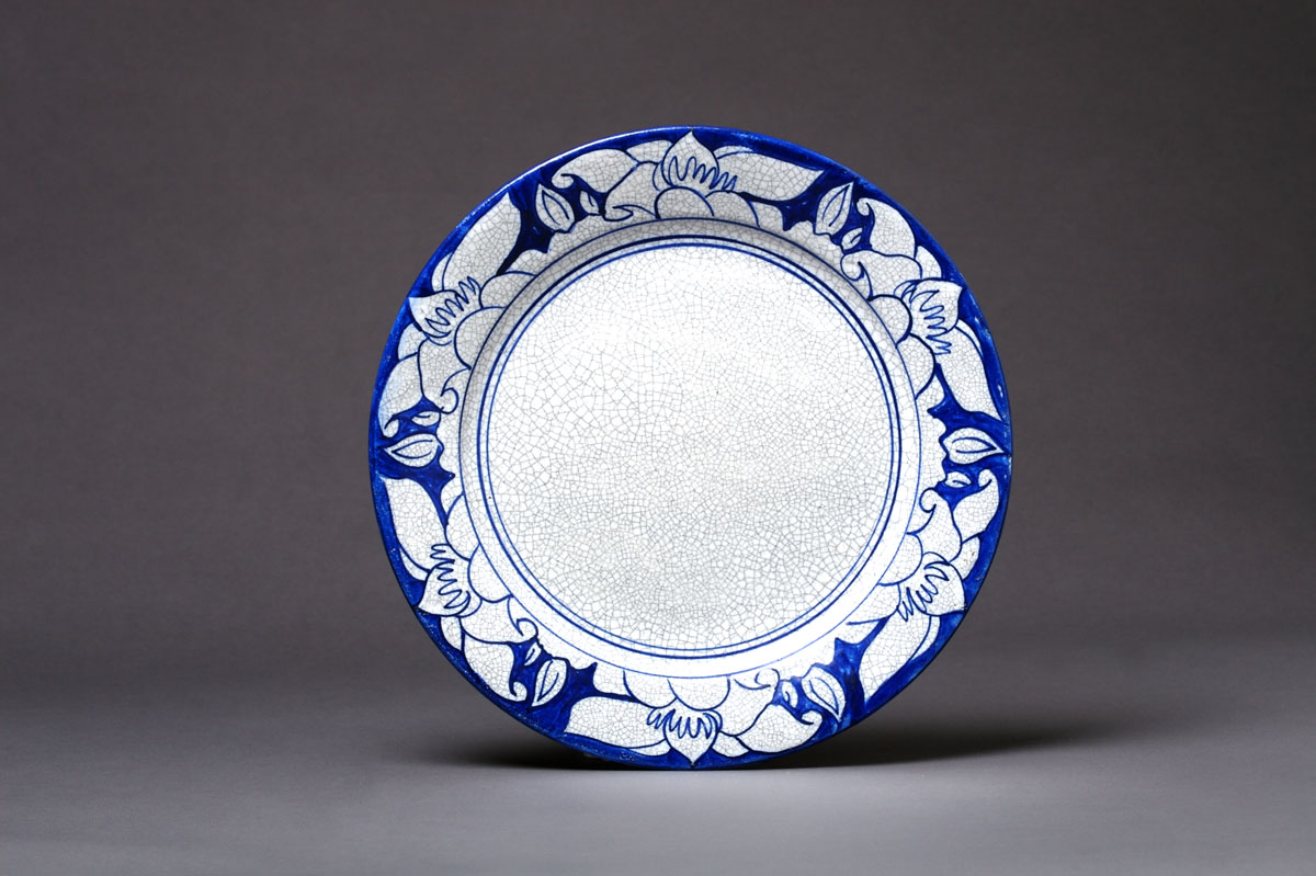 Appraisal: DEDHAM POTTERY 'MAGNOLIA' PATTERN PLATE Painted in bright blue with