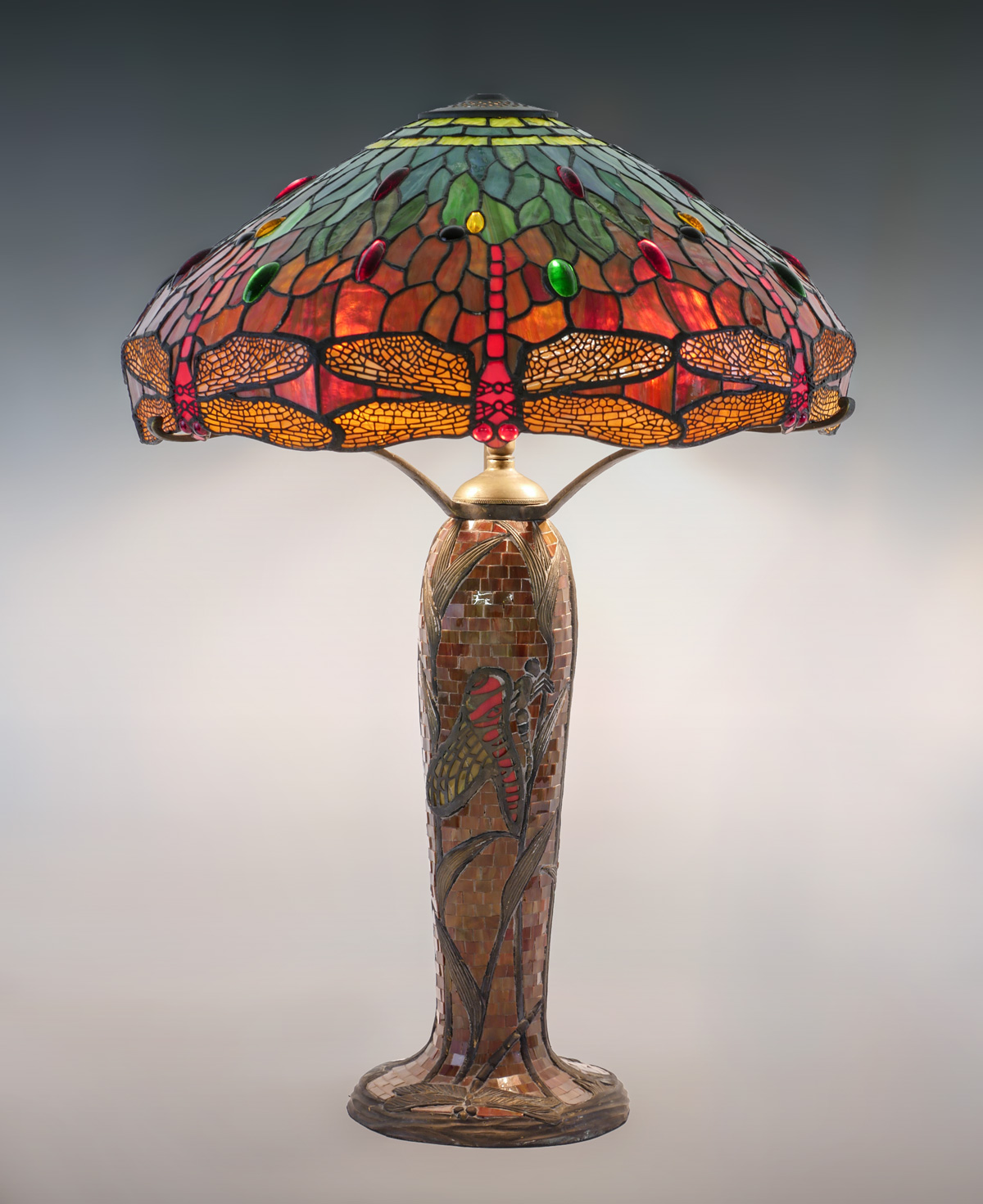 Appraisal: TIFFANY STYLE DRAGONFLY LAMP Mosaic light base with a dragonfly