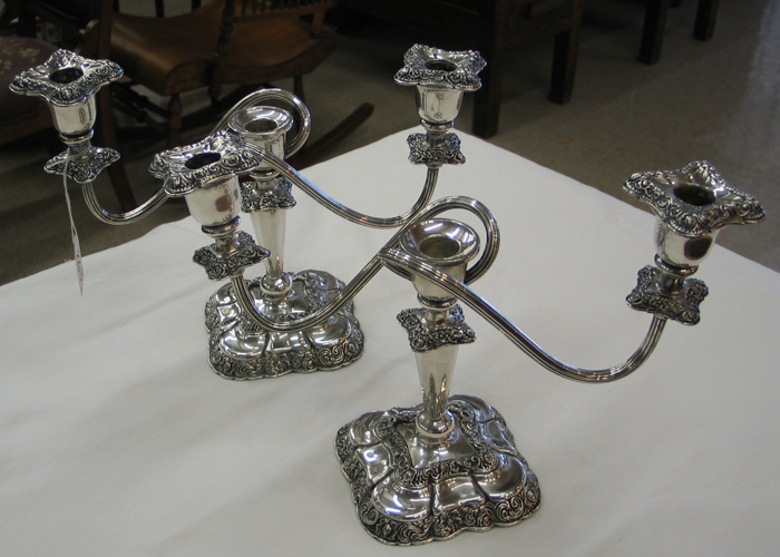 Appraisal: PAIR OF AMERICAN SILVERPLATED ORNATE THREE-LIGHT CANDELABRA on curved stems