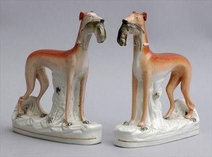 Appraisal: PAIR OF STAFFORDSHIRE FIGURES OF WHIPPETS Modeled mirror images with