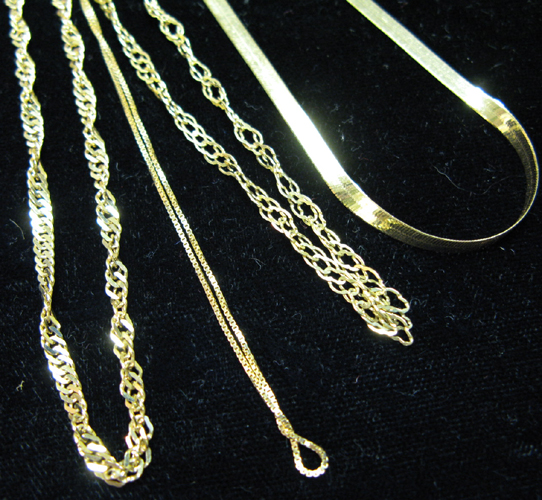 Appraisal: FOUR YELLOW GOLD CHAIN NECKLACES AND A PENDANT the chains