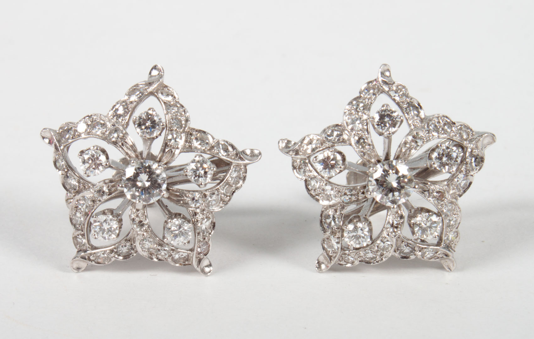 Appraisal: Pair of white gold diamond star-form earrings center diamond about