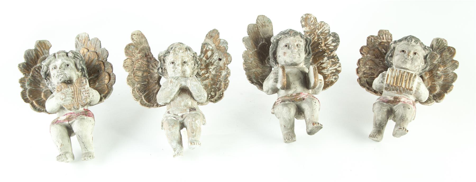 Appraisal: FOUR CARVED CHERUBS WITH MUSICAL INSTRUMENTS European th century Gessoed