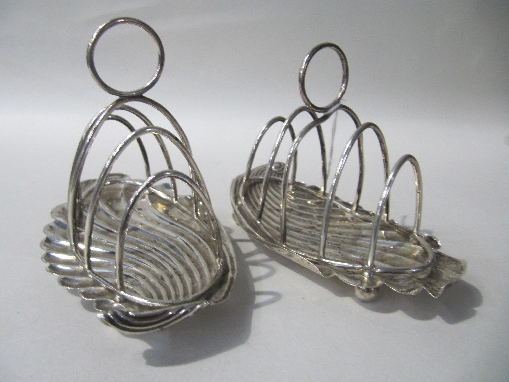 Appraisal: Pair of silver leaf shaped toast racks Birmingham marks