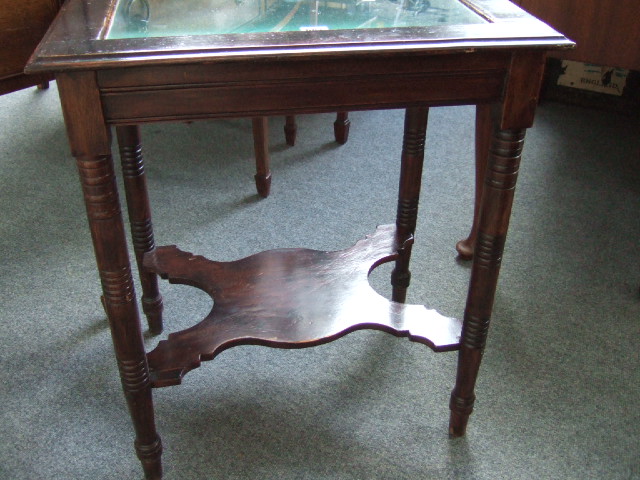 Appraisal: A stained beech bijouterie table the hinged glazed pivet top