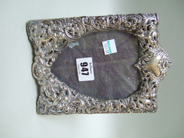 Appraisal: A Victorian silver mounted shaped rectangular photograph frame embossed with