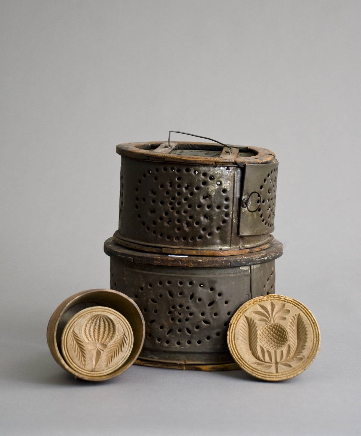 Appraisal: TWO EARLY AMERICAN PUNCHED TIN FOOT WARMERS OF CIRCULAR FORM